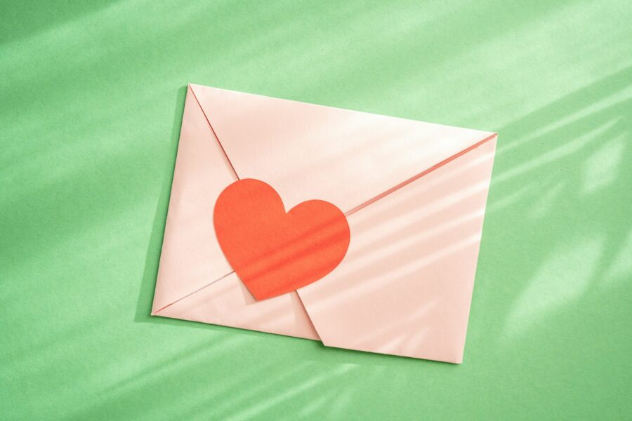 Love envelop on green natural background